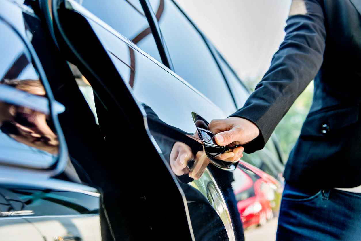Chauffeur opening a luxury car door